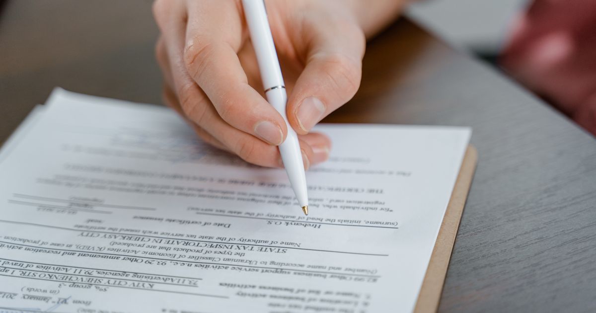 Completing a health insurance claim form by hand