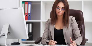 Medical billing specialist reviewing rejected insurance claims at a desk