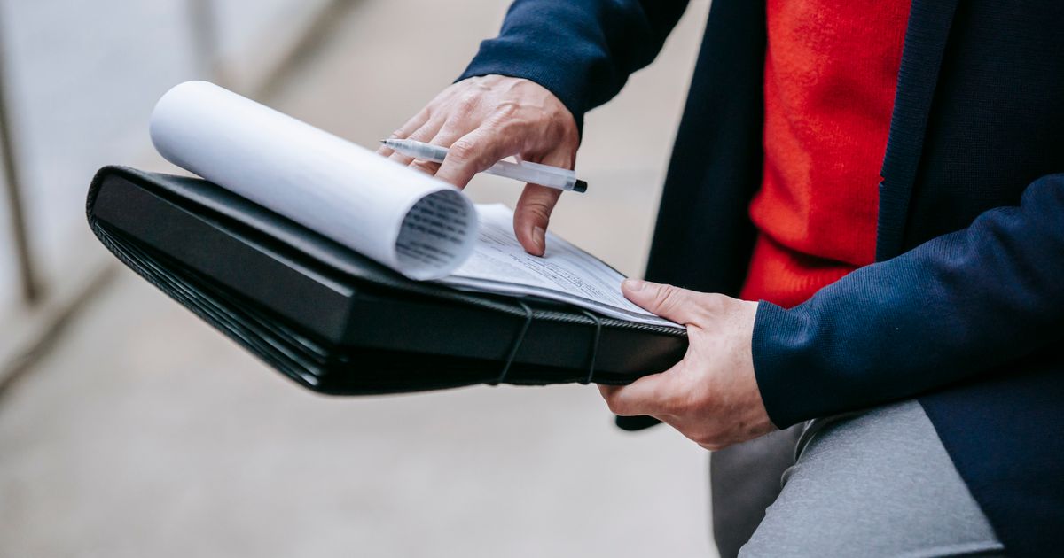 Billing team reviewing claim documents and paperwork at an office desk